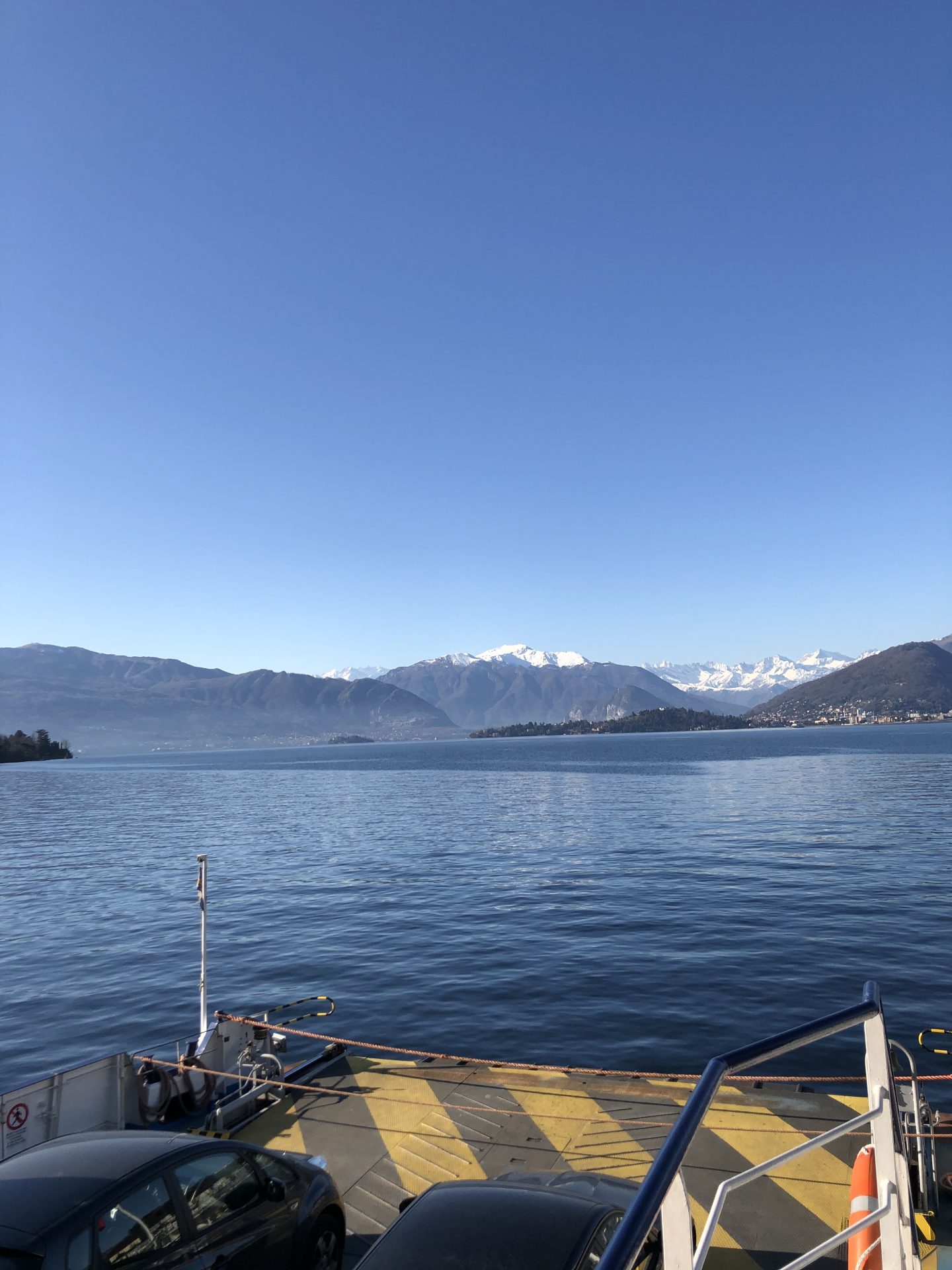 A view from the car ferry across Lake Maggiore, on our way to our family skiing holiday in Zermatt, snowy alps visible in the distance.