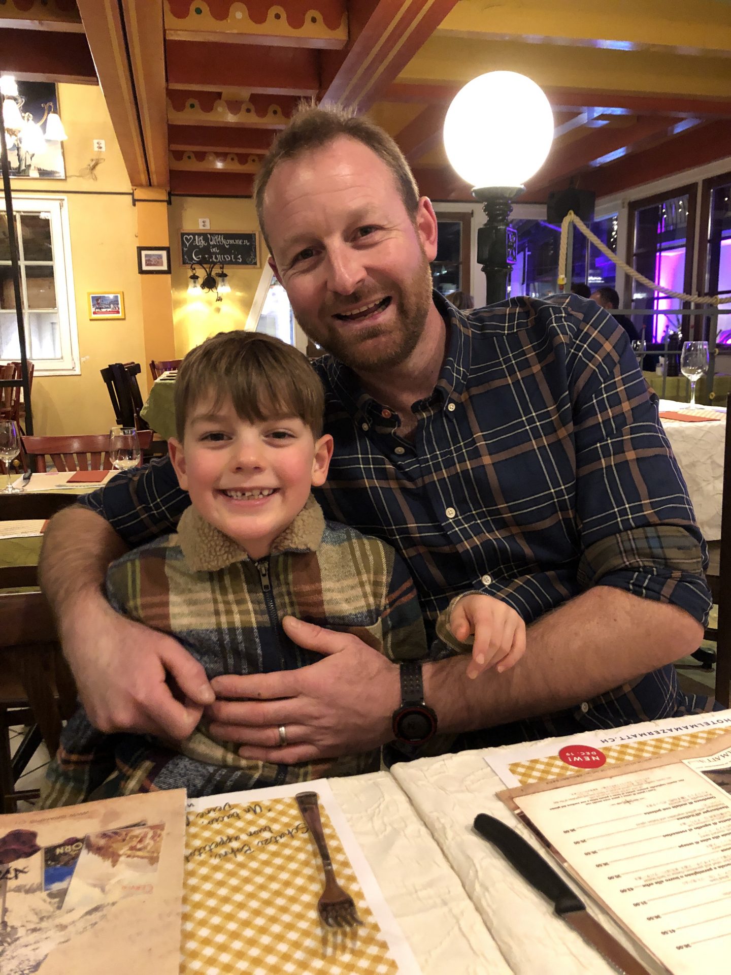 My husband and son posing during dinner at Grampis restaurant, Zermatt