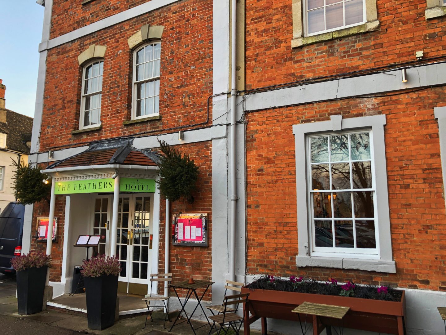 An outside shot of the red brick The Feathers Hotel Woodstock.