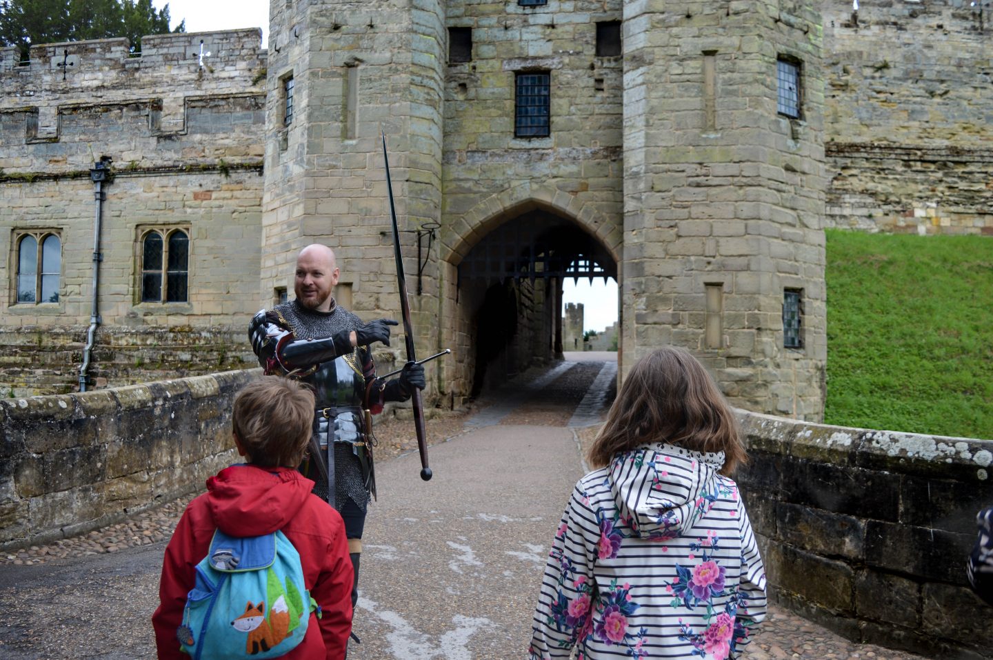A Knight leads the way into the Castle which is open again to visitors.