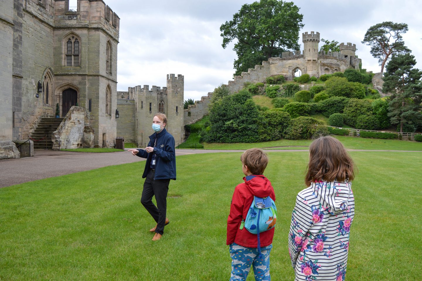 The history tour guide wearing a mask at Warwick Castle, open with safety measures in place.