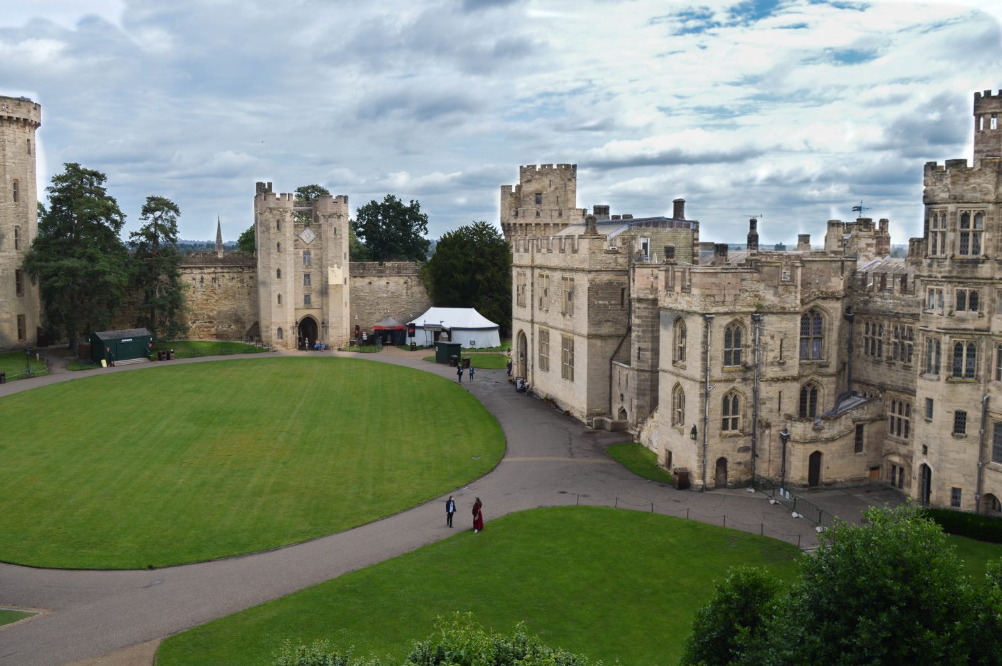 The beautiful Warwick Castle, open to guests and standing majestically against a dramatic, moody sky.