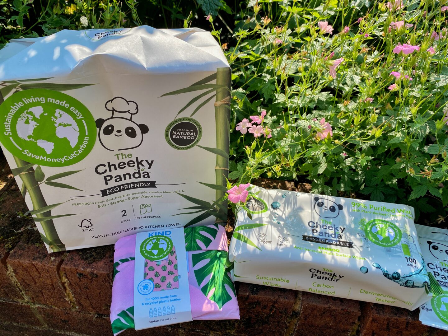 A selection of Cheeky Panda wipes and bamboo kitchen towel and a beautiful pink Kind reusable shopper.